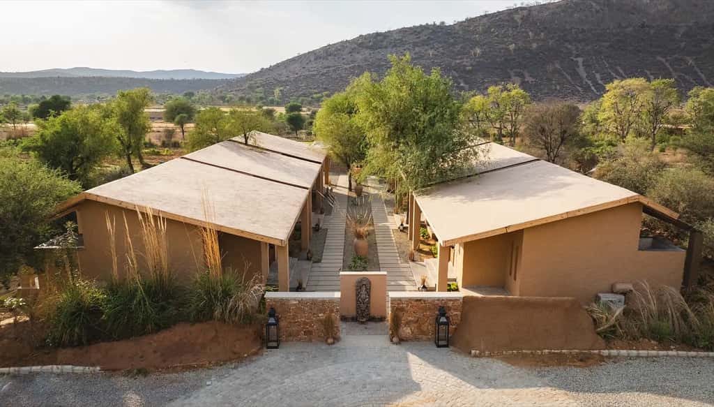 Villa roofs seen from above against bare hills