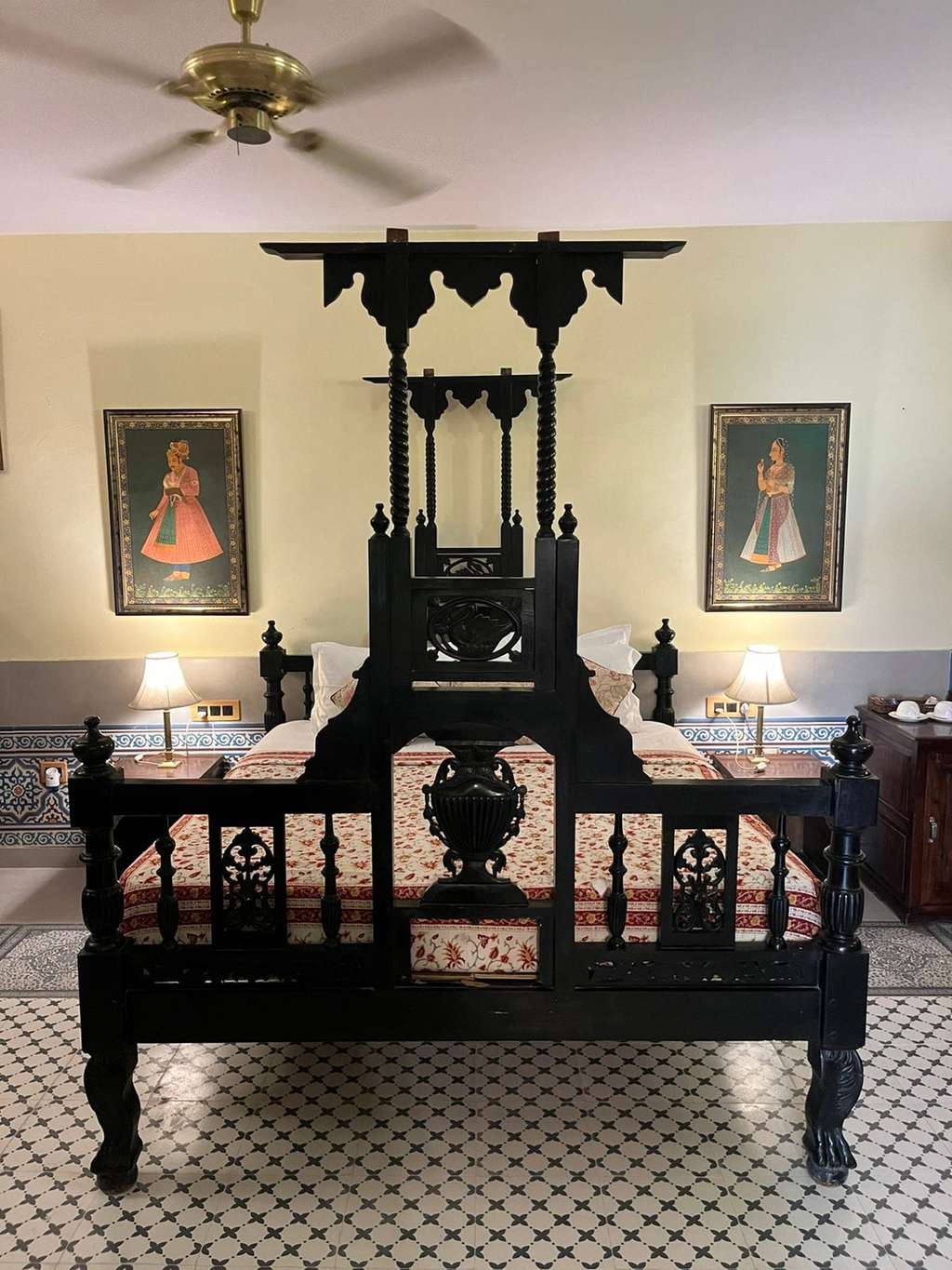Carved dark wood bed in chamber