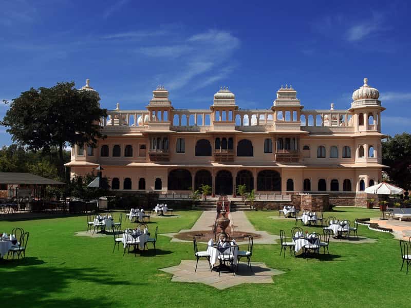Palace facade and lawn under blue sky