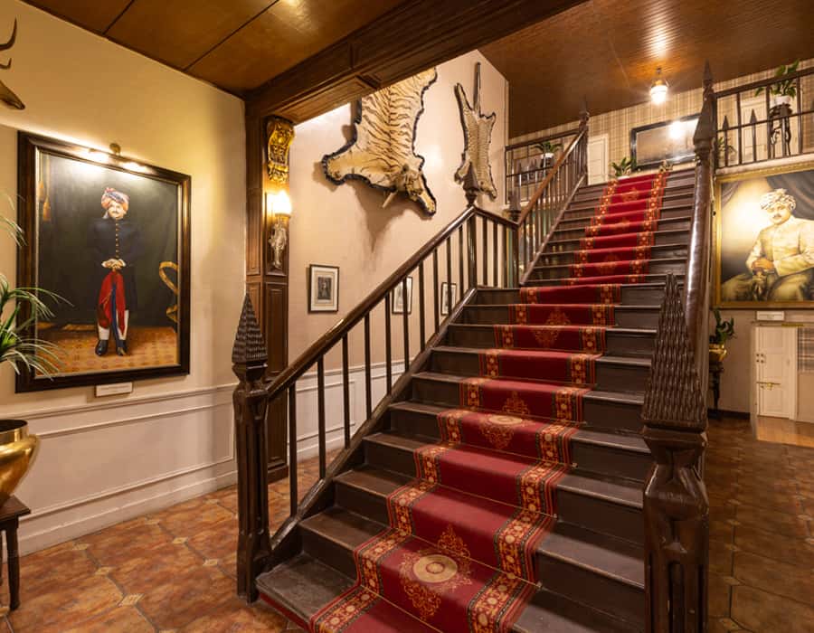 Staircase with red runner and mounted trophies
