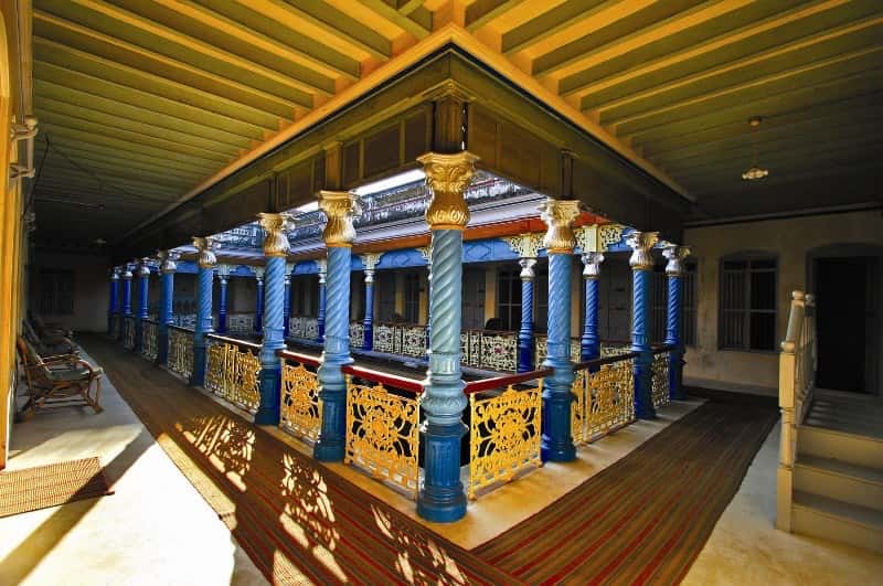 Upper gallery with blue columns and gilded capitals
