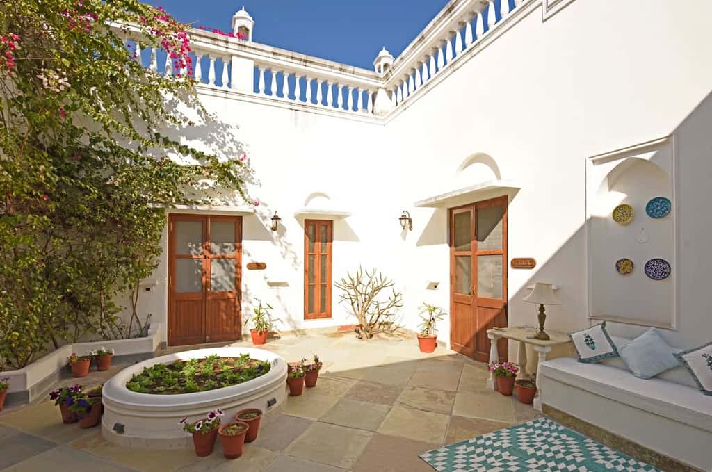 Courtyard with blue trim and planted bed