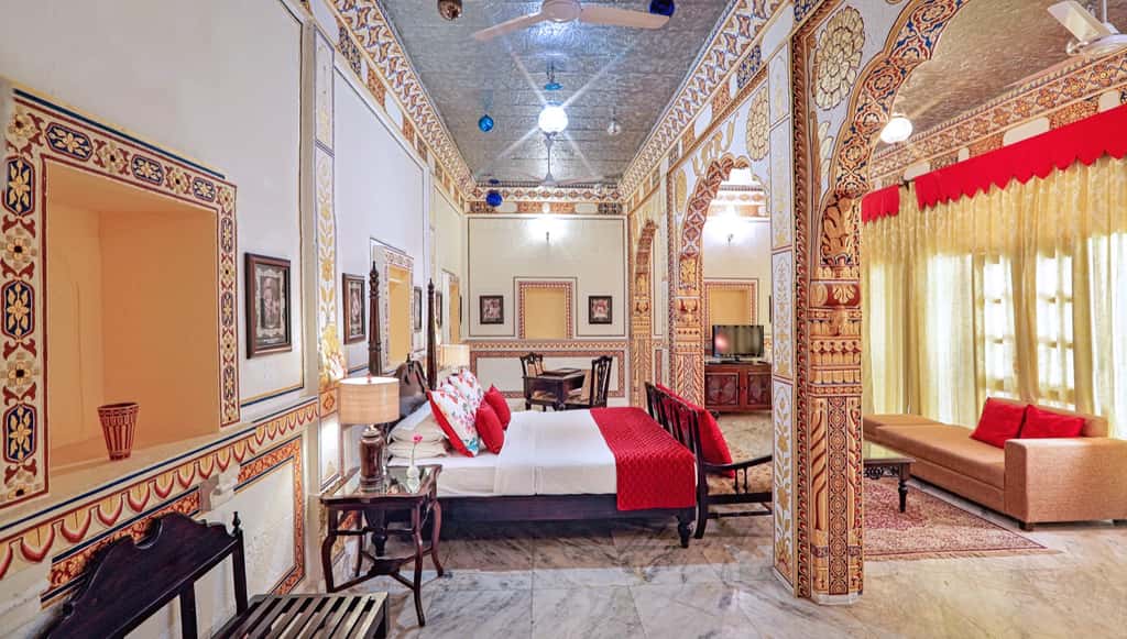 Painted suite with carved doorway and red drapes