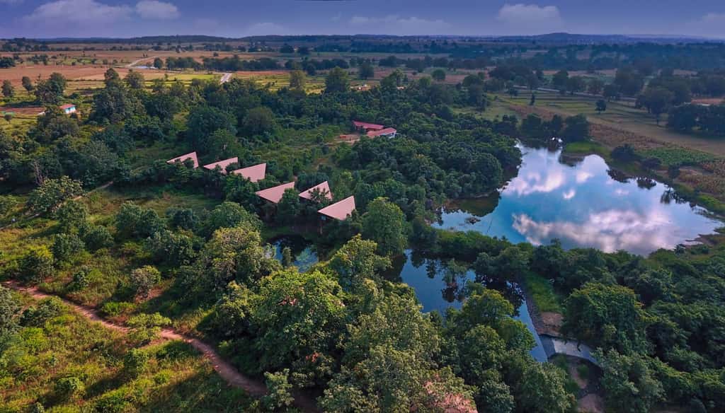 Pench Tree Lodge from the air, roofs and the lake in forty acres of forest