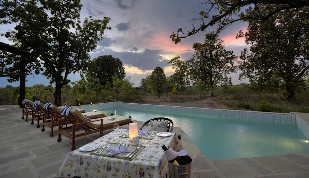 The pool at Pench Tree Lodge at sunset