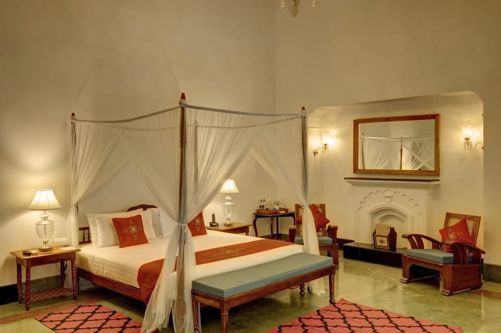 Heritage Suite with a canopied four-poster bed, fireplace and chandelier, Saraca Hotel Lucknow, Lucknow