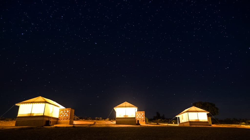 Three tents glowing under a starry desert sky, Dhora Desert Resort & Spa, Shekhala