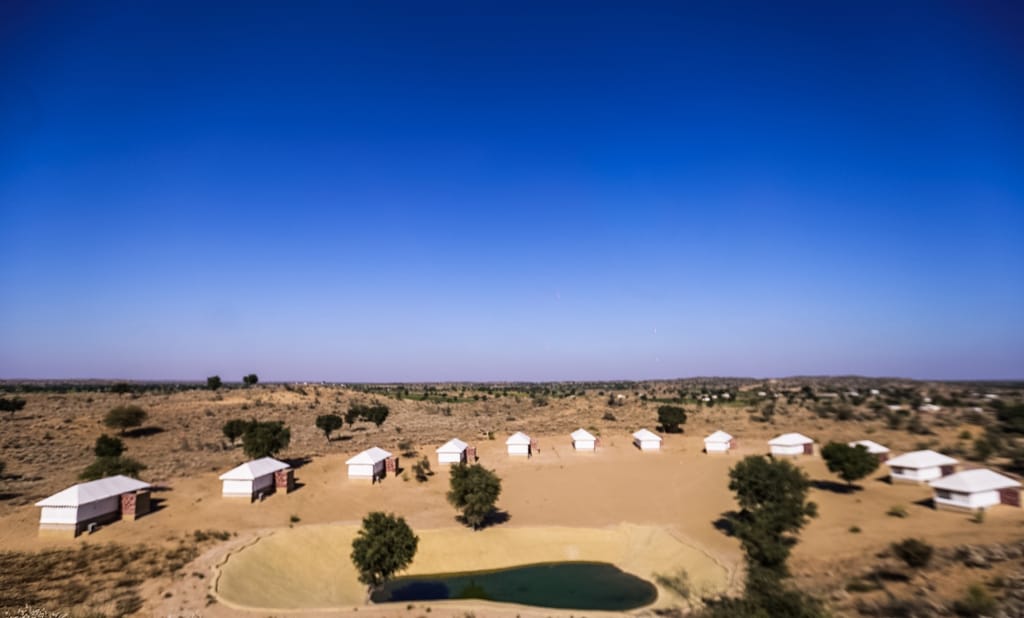 Tented suites facing the pond framed by dunes, Dhora Desert Resort & Spa, Shekhala