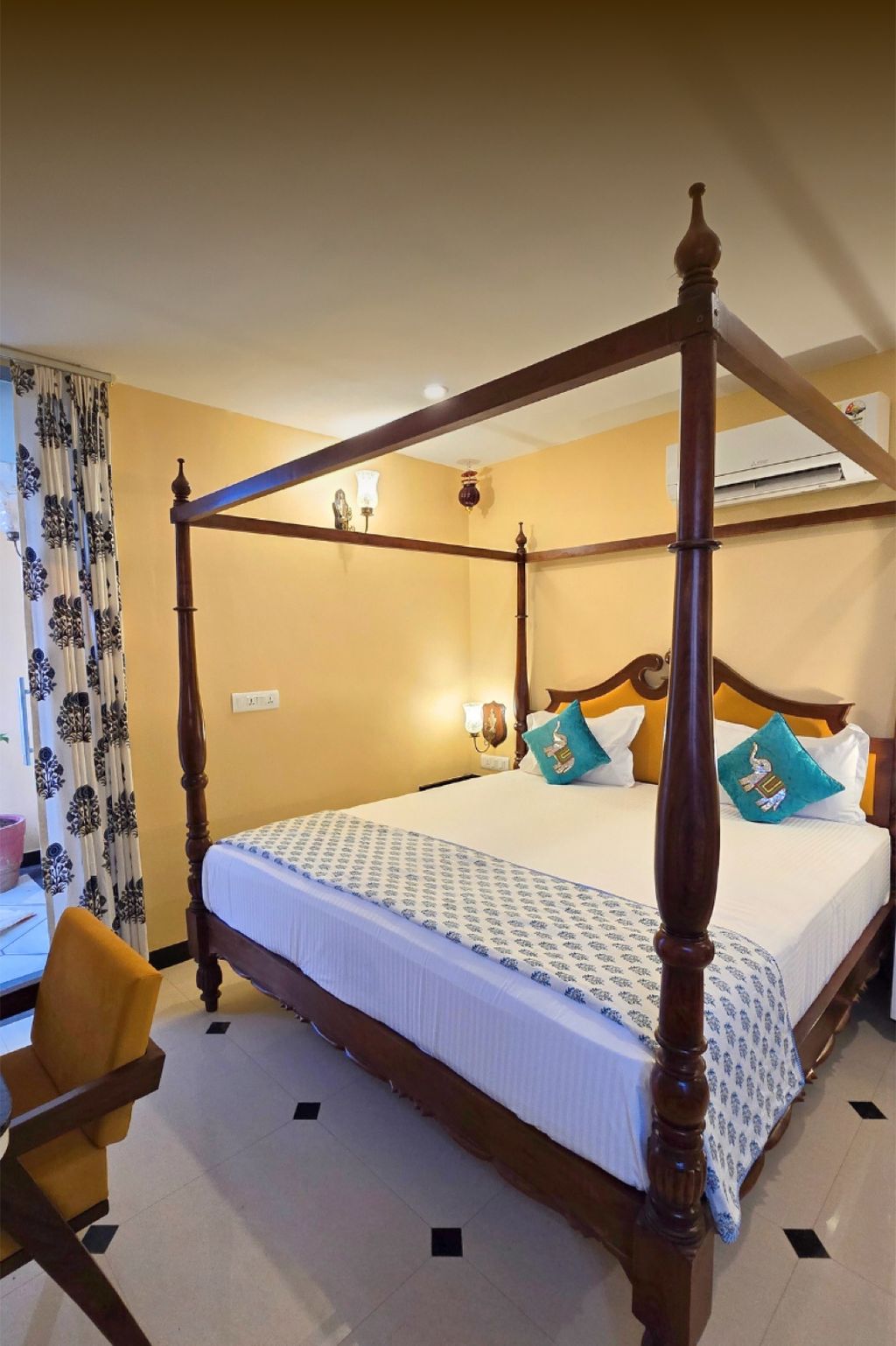 Bedroom with carved four-poster bed and block-printed linens, Diwan House, Agra