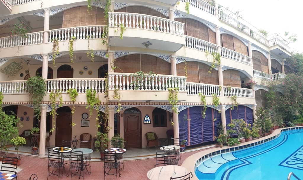 Balconied facade and courtyard tables, Jas Vilas, Jaipur