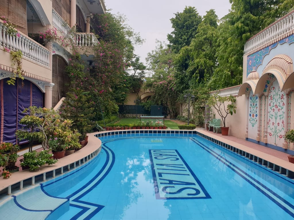 Swimming pool with hand-painted mural wall and Jas Vilas lettering, Jas Vilas, Jaipur