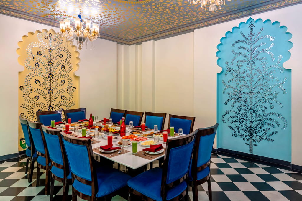 Kesari multi-cuisine restaurant with teakwood chairs and chandeliers, Kesar Bagh Palace, Chittorgarh