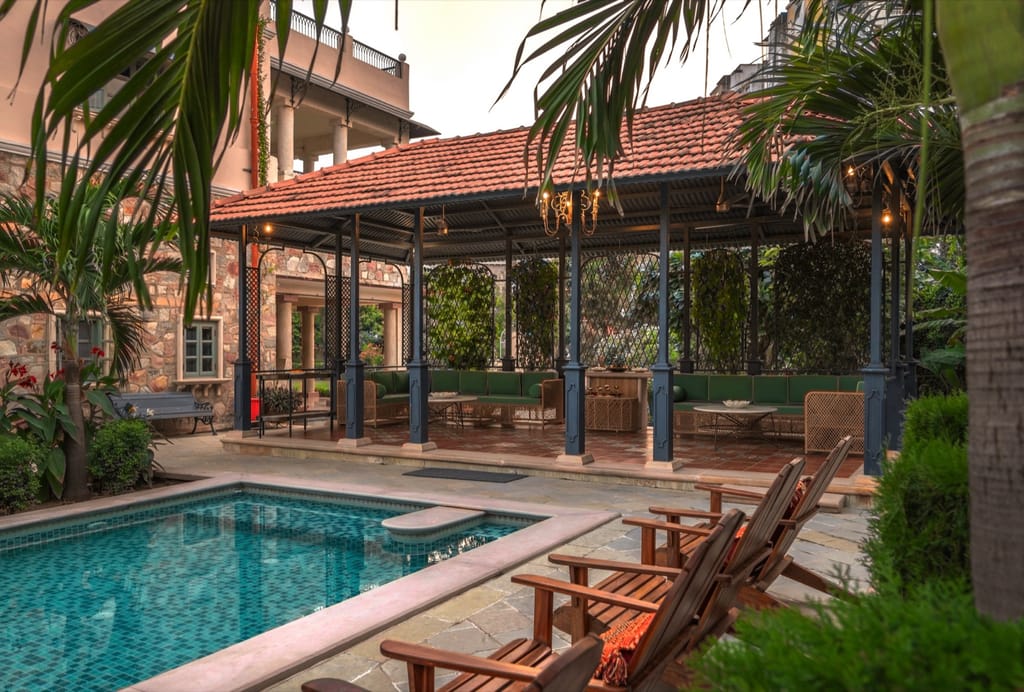 Lounge pool and chandelier-lit garden gazebo at dusk, Niravi, Jaipur