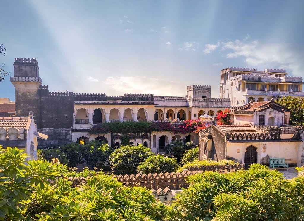 Crenellated rooftops, arched balconies and bougainvillea of the 17th-century retreat, Rawla Narlai, Narlai