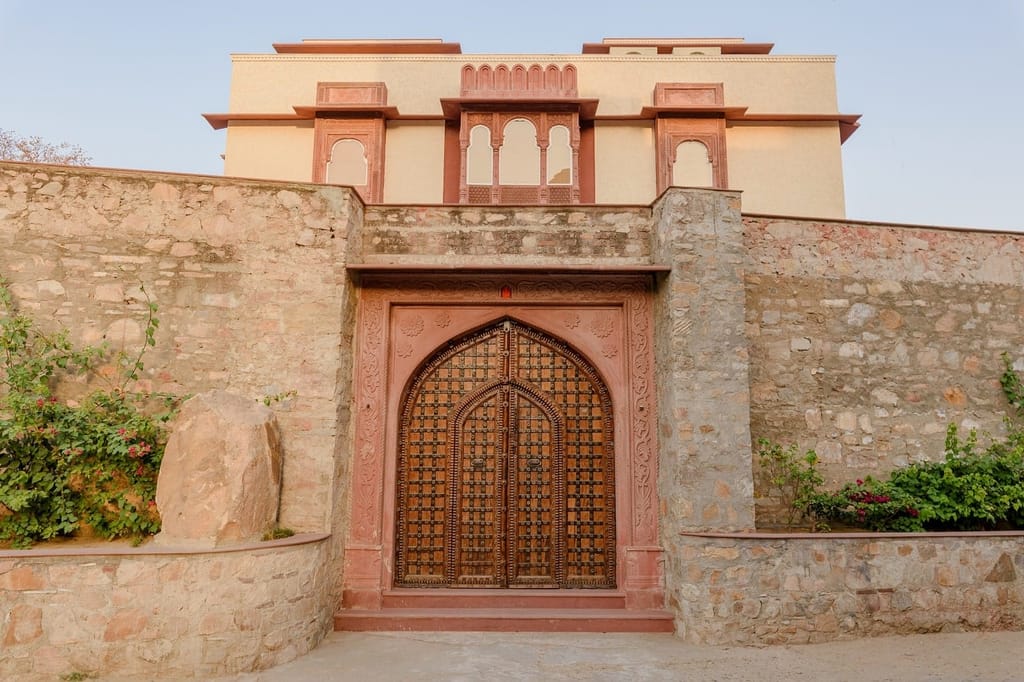 Arched gateway and stone walls at the entrance, Surya Haveli, Amer, Jaipur