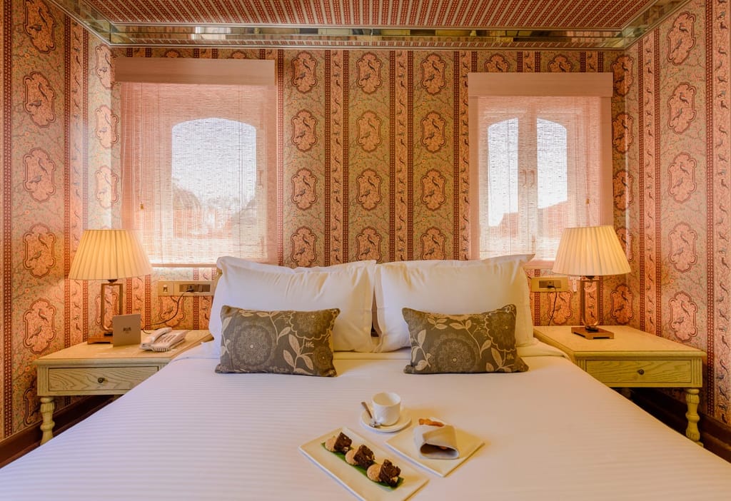 Bedroom with bespoke wallpaper and twin lamps, Surya Haveli, Jaipur