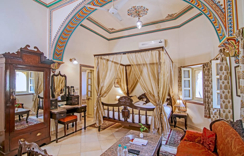 A carved poster bed under a canopy