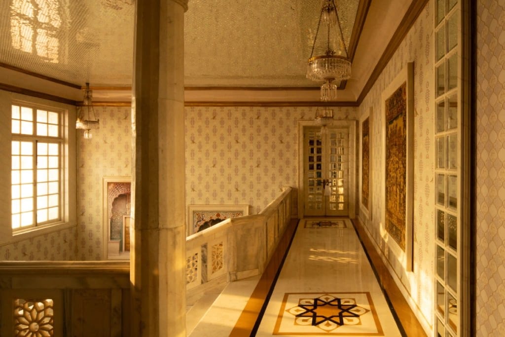 A marble gallery inlaid with a star, lit through tall windows