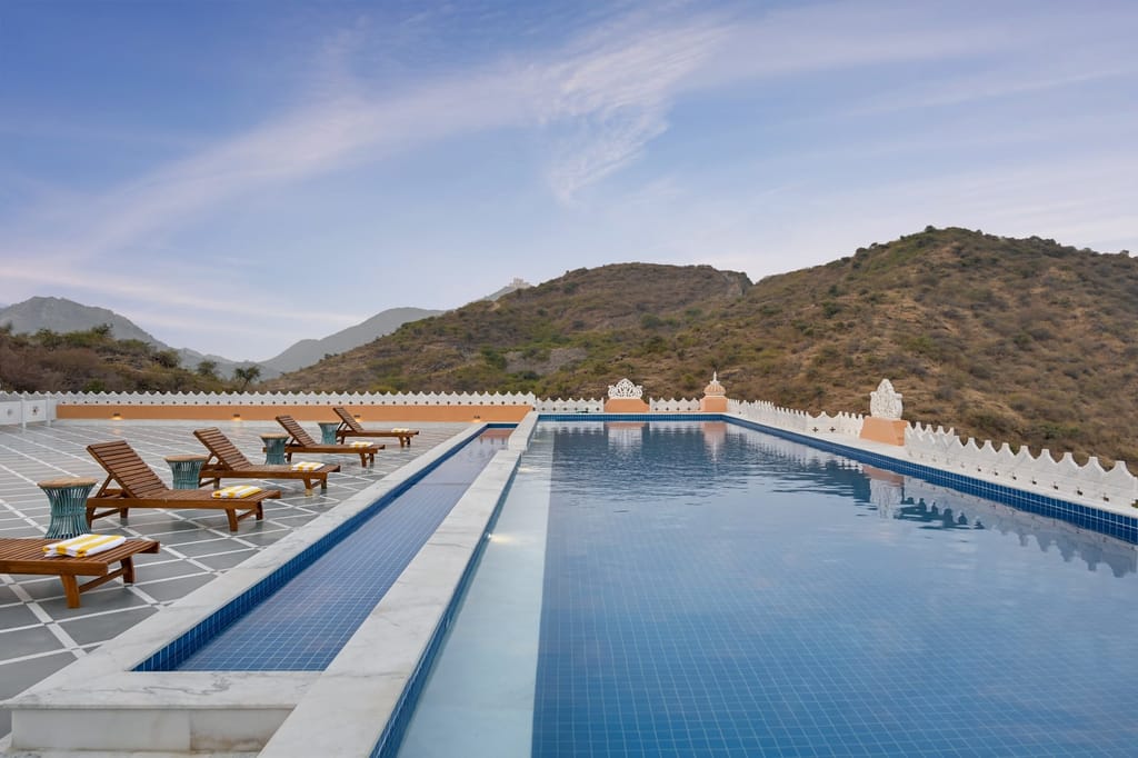 Swimming pool with loungers
