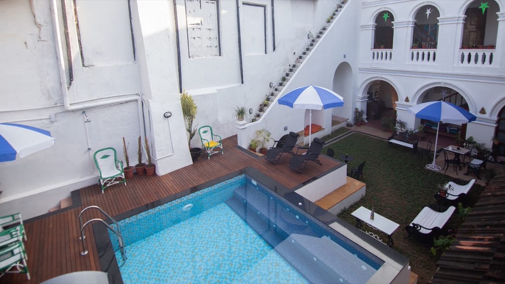 View down into The Old Courtyard Hotel courtyard from the first floor gallery, pool and arches below