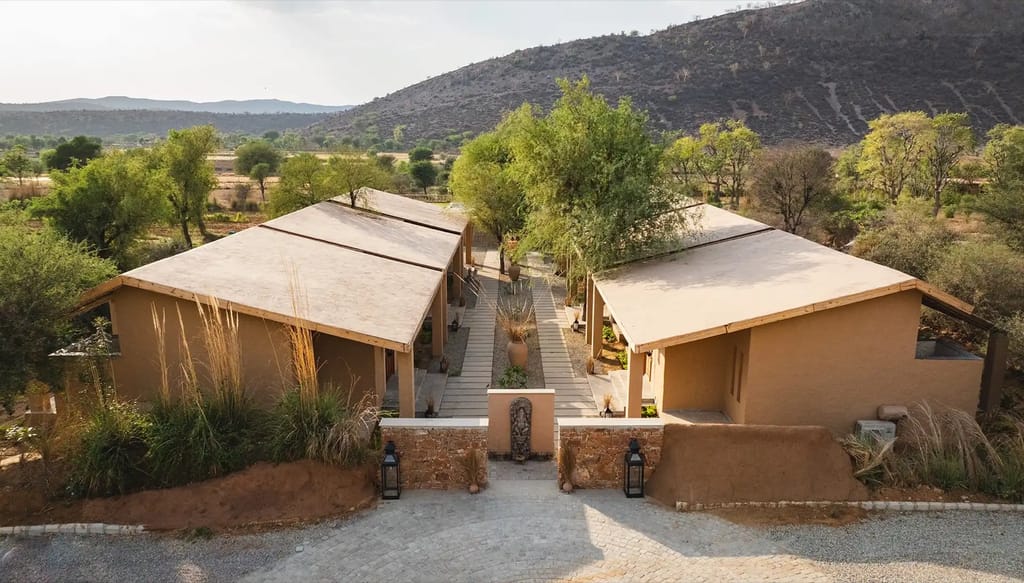 Villa roofs seen from above against bare hills