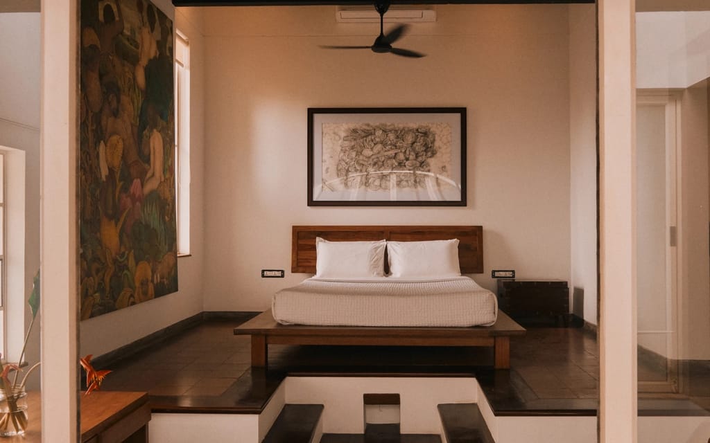 Heritage room with low bed and framed artwork