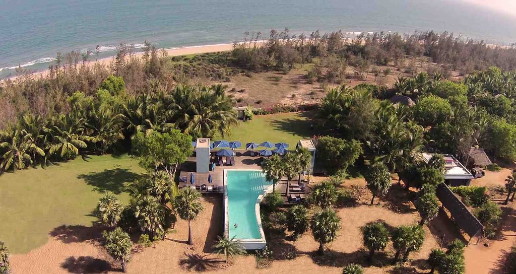 Swimming pool and lawn seen from above the beach