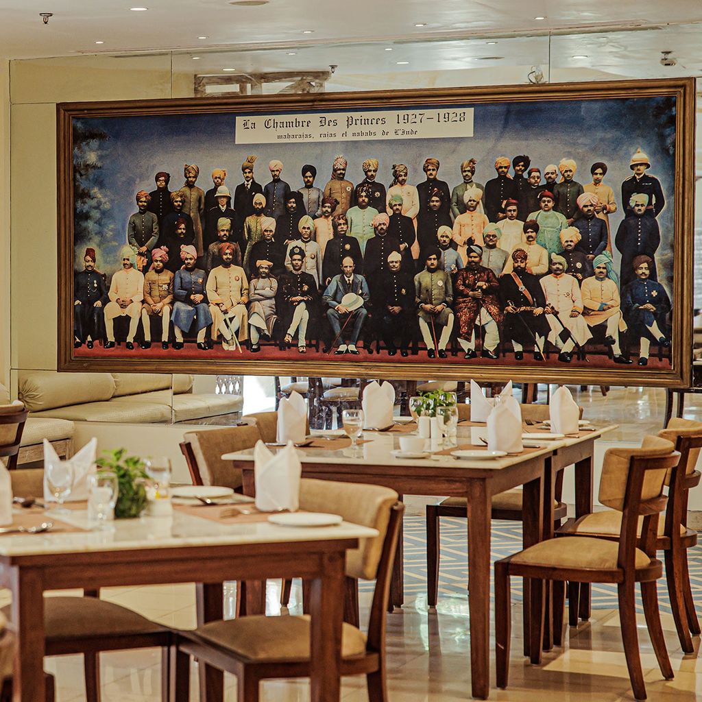 Cafe tables below historic group photograph