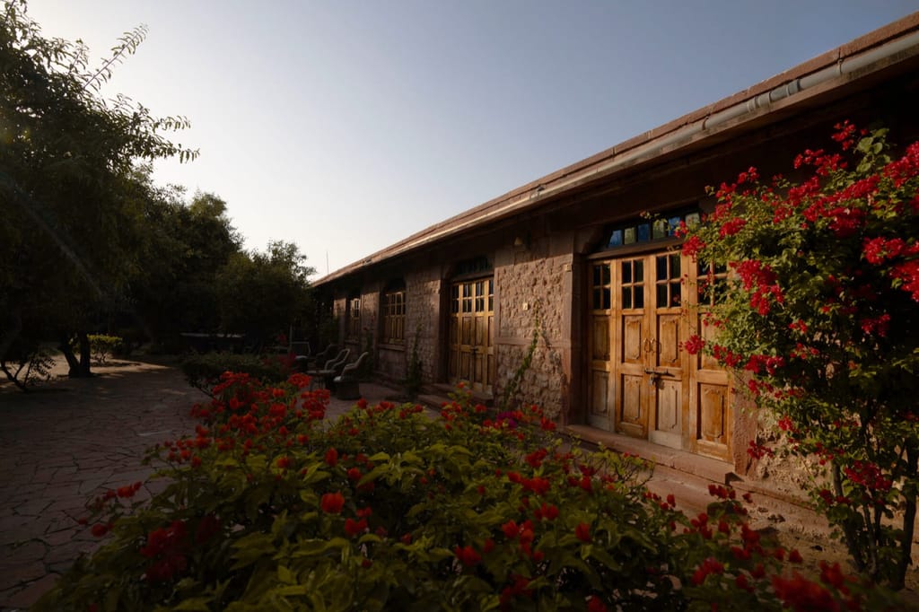 Long stone room block behind flowering bougainvillea