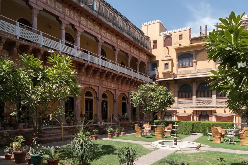 Main courtyard with two tiers of arcaded galleries and a fountain set into the lawn