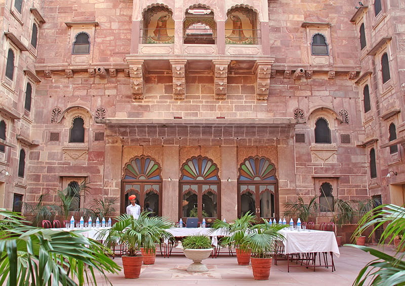 Sandstone facade with carved jharoka balconies