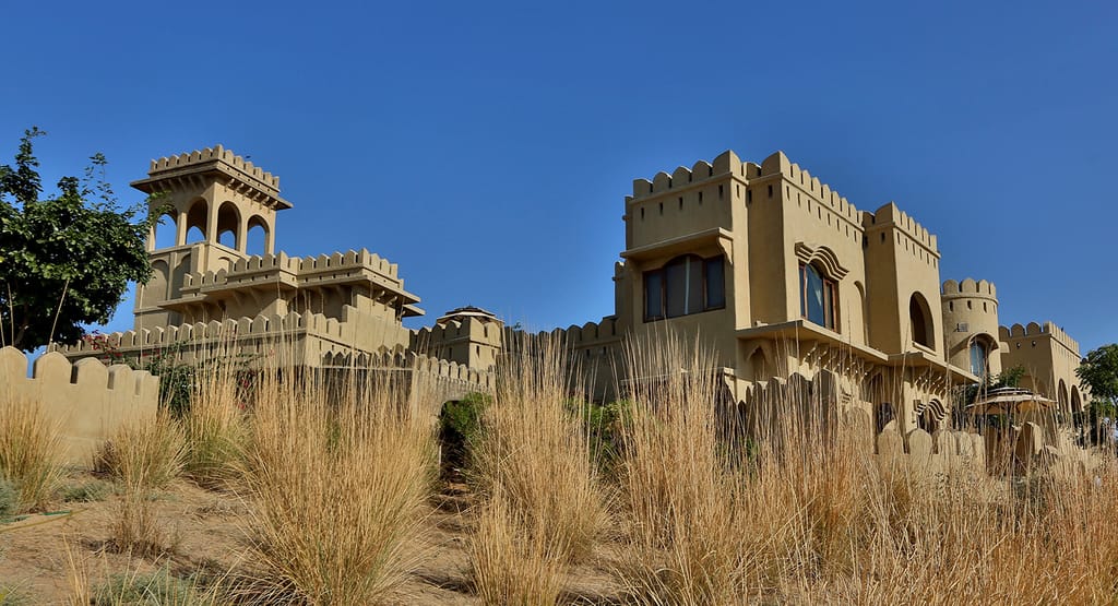 Sandstone fort rising from a desert dune