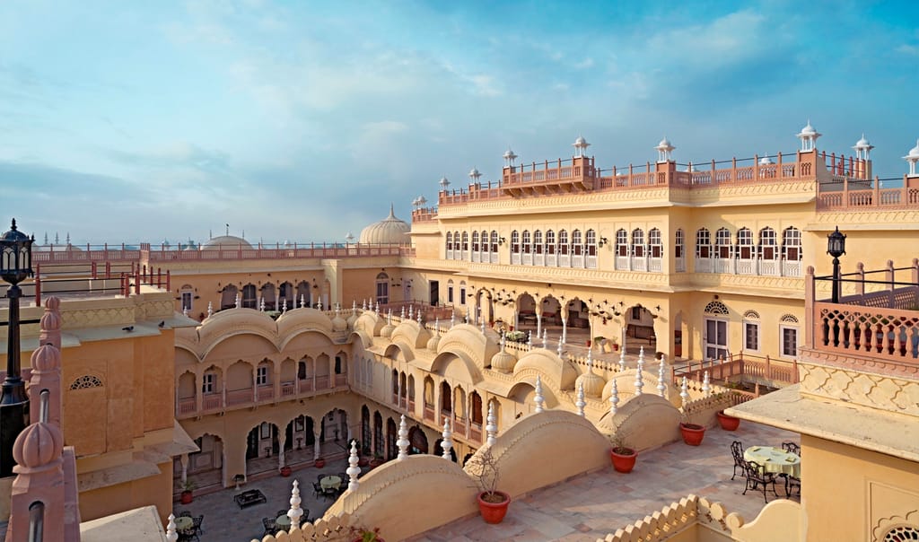 Palace terraces and domed roofs with tables set out along a balustrade above the courtyard