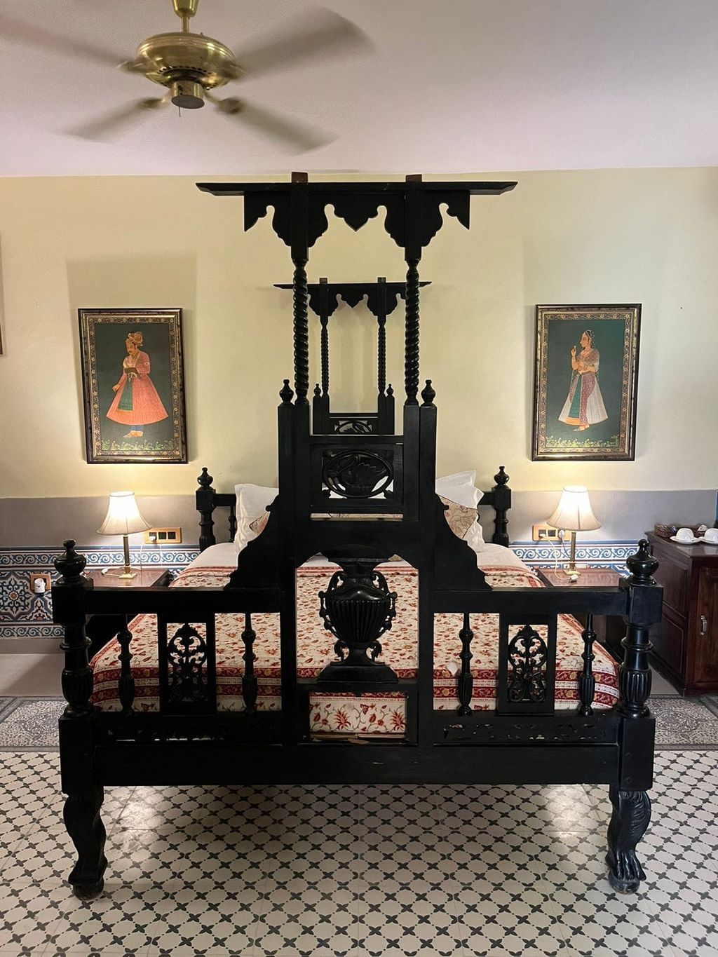 Carved dark wood bed in chamber