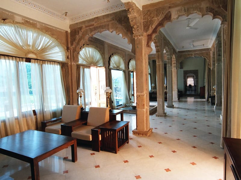 Carved stone pillars along a shaded verandah