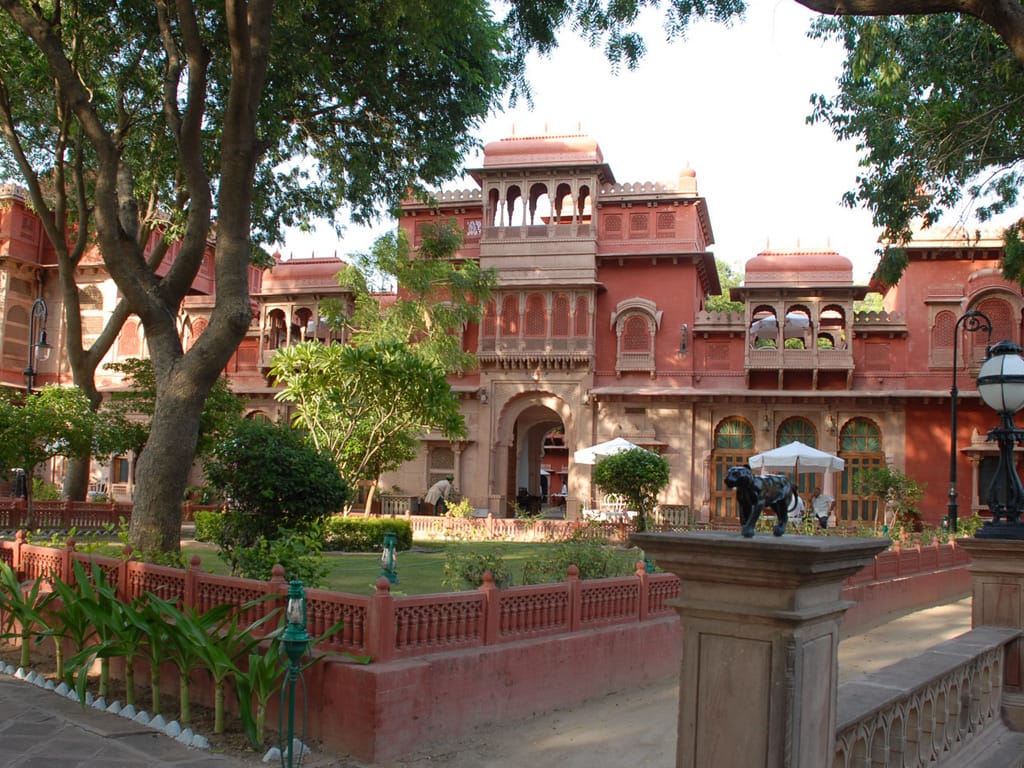 Red sandstone palace facade above the garden