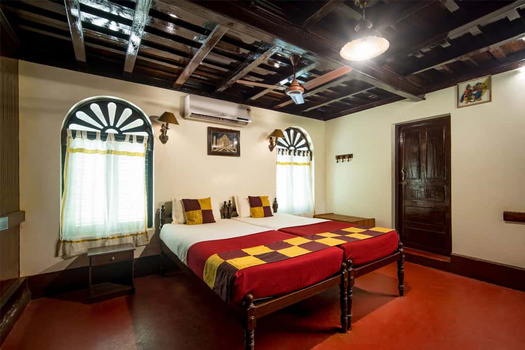 Heritage room with arched windows and a beamed ceiling
