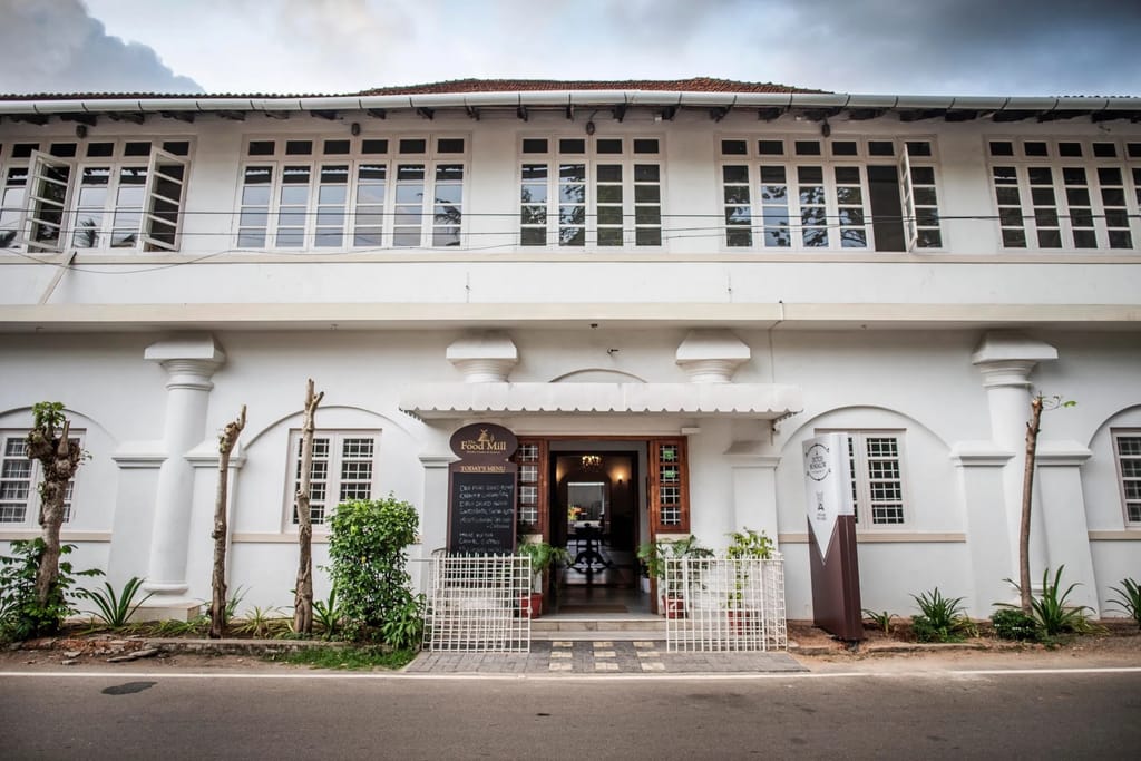 White colonnaded street facade of the bungalow