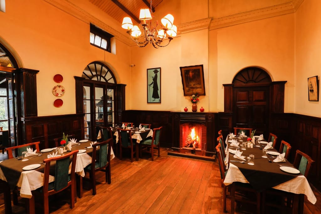 Panelled dining room with lit fireplace