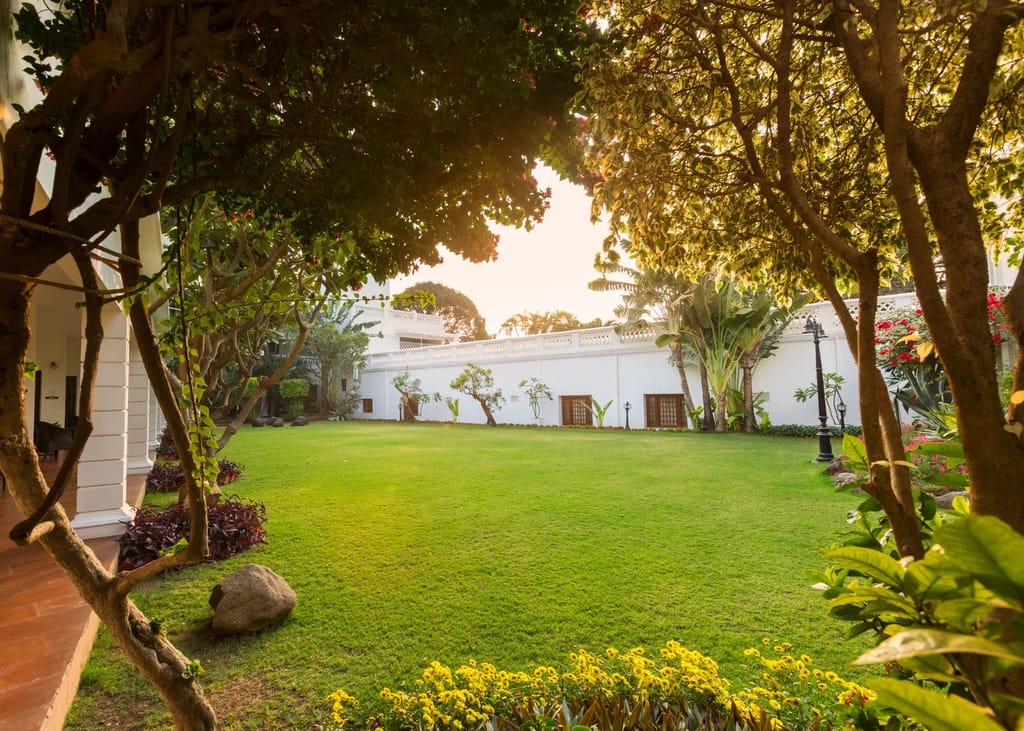 Lawn and arcaded wing under old trees