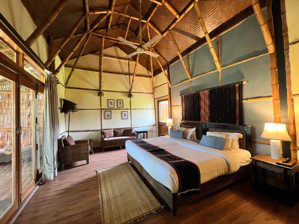 A cottage bedroom under a vaulted bamboo roof