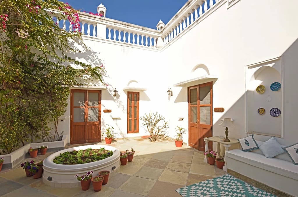 Courtyard with blue trim and planted bed