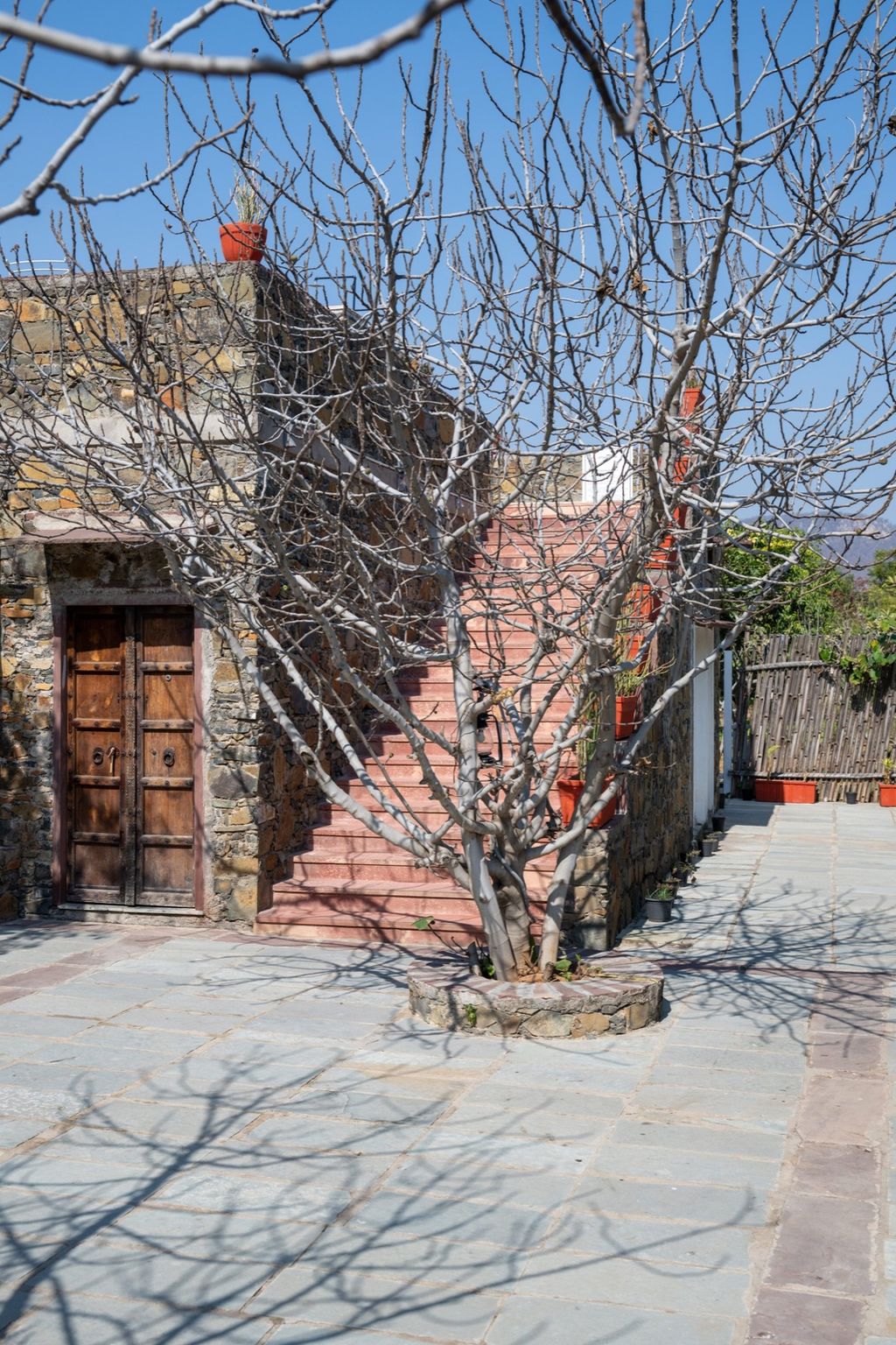 Stone building with carved wooden door and sandstone steps