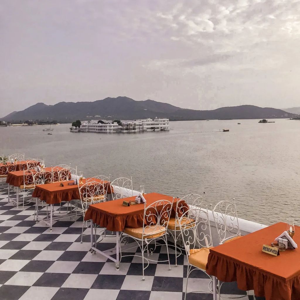 Chandni rooftop tables above Lake Pichola facing the Lake Palace at sunset, Jagat Niwas Palace, Udaipur