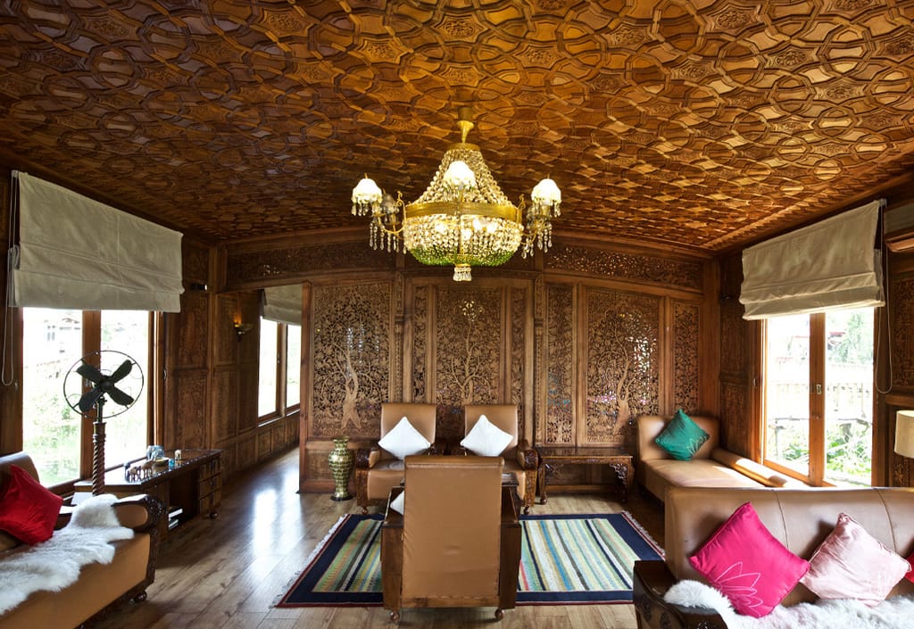 Living room with khatamband ceiling and carved screens