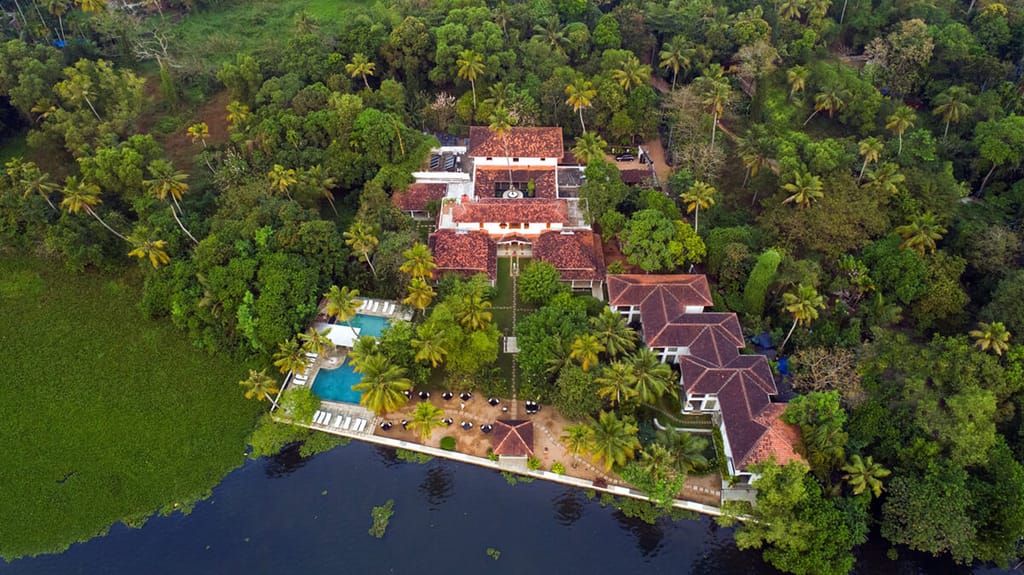 Aerial view of the property and pool on the lakeshore