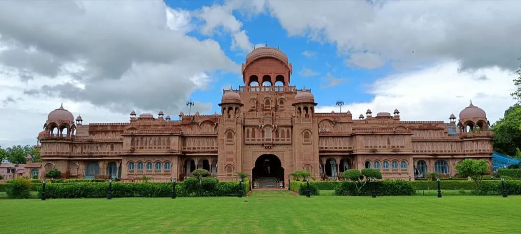 The Laxmi Niwas Palace and its front gardens under a monsoon sky, Bikaner
