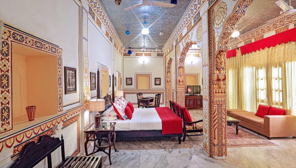 Painted suite with carved doorway and red drapes
