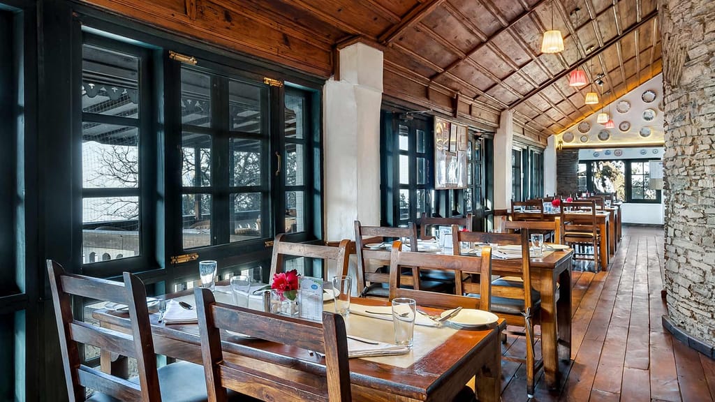 Restaurant interior with wood ceiling and long tables