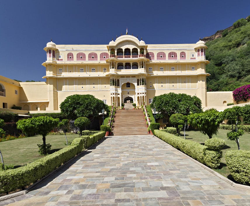 Palace facade above formal garden and driveway